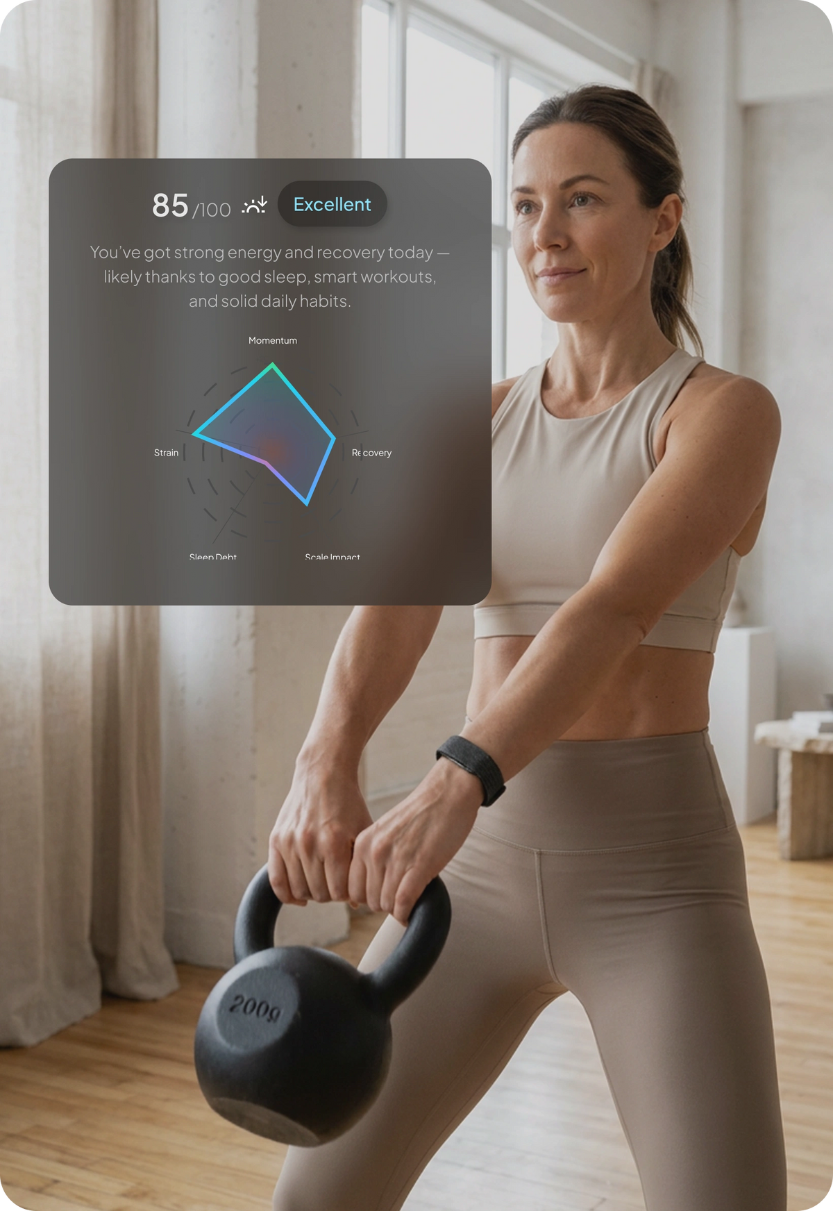 Person wearing a hume band 2.0 while performing a kettlebell exercise indoors. A wellness dashboard overlay displays an energy and recovery score of 85/100 rated as “Excellent,” along with metrics for momentum, recovery, strain, sleep debt, and scale impact.